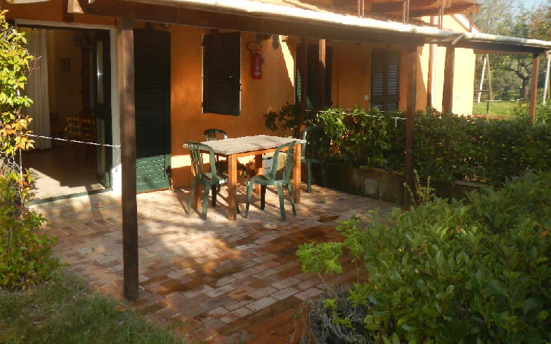 Il patio coperto di un appartamento con tavolo e sedie